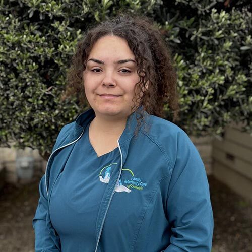 Jasmine outside the clinic in front of a bush