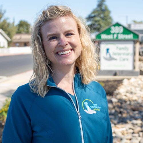 Mary smiling with the clinic sign in the background