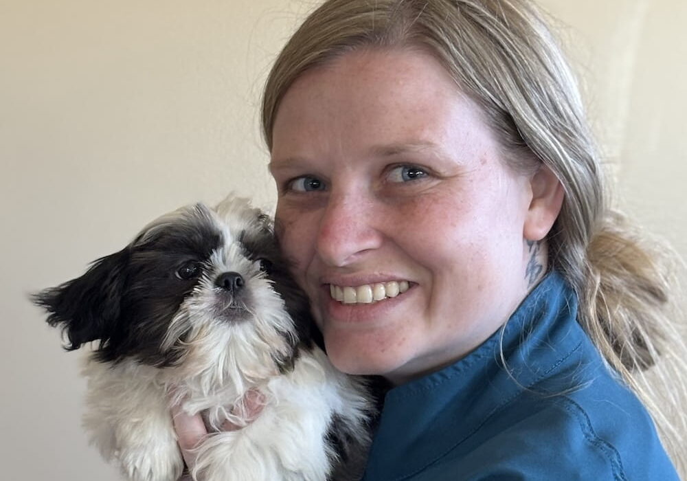 Woman Holding Black And White Dog